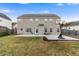 Spacious backyard with a large concrete patio, and basketball hoop and a clear blue sky at 2902 Framer Ln, Durham, NC 27704