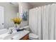 This is a cozy bathroom featuring a decorative mirror, toilet, and a shower tub at 2902 Framer Ln, Durham, NC 27704