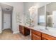 A modern bathroom with a double vanity, large mirrors, and decorative details above the sinks at 2902 Framer Ln, Durham, NC 27704