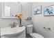 Stylish half bathroom features an elegant mirror, contemporary sink, and tasteful wall decor at 2902 Framer Ln, Durham, NC 27704