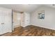 A hardwood bedroom includes multiple doors, closet, and access to the staircase at 2902 Framer Ln, Durham, NC 27704