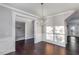 Dining room features hardwood floors, classic trim, chandelier, and large window at 2902 Framer Ln, Durham, NC 27704