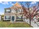 Charming two-story home with a well-manicured lawn, brick facade, and a large tree in the front yard at 2902 Framer Ln, Durham, NC 27704