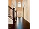Elegant foyer with gleaming hardwood floors, a soaring ceiling, and a staircase with decorative iron railings at 2902 Framer Ln, Durham, NC 27704