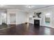 Inviting living room with a cozy fireplace and seamless access to other rooms, hardwood floors throughout at 2902 Framer Ln, Durham, NC 27704