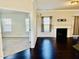 Open-concept living area with hardwood floors, fireplace, and views into the adjacent carpeted room at 2902 Framer Ln, Durham, NC 27704