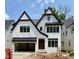 Striking new construction home featuring white brick, black trim, and a modern architectural design at 3008 Eden Harbor Ct, Raleigh, NC 27613