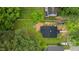 Aerial view shows the lush greenery surrounding the home, backing up to other residential properties at 306 Coleman St, Oxford, NC 27565