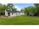 Lush backyard with a swing set behind the house and room for activities at 306 Coleman St, Oxford, NC 27565