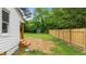 Spacious backyard featuring a new wooden fence, green shed, and wooded border at 306 Coleman St, Oxford, NC 27565