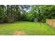 Large backyard featuring a green storage shed and newly installed wooden fence at 306 Coleman St, Oxford, NC 27565