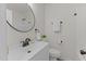 Bright bathroom with vanity, round mirror, and toilet at 306 Coleman St, Oxford, NC 27565