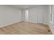 Bright bedroom featuring neutral walls, wood floors, and closet at 306 Coleman St, Oxford, NC 27565