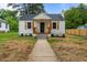 Charming home featuring a walkway leading to the front door and neat landscaping at 306 Coleman St, Oxford, NC 27565