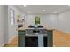 Well-equipped kitchen island with stovetop and appliances overlooking the dining and living areas at 306 Coleman St, Oxford, NC 27565