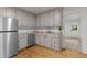 Modern kitchen with stainless steel appliances, light countertops, and stylish cabinets at 306 Coleman St, Oxford, NC 27565