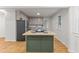 Modern kitchen with a central island, stainless steel appliances, and stylish cabinets at 306 Coleman St, Oxford, NC 27565