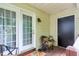 Cozy back porch area with seating, a door, and a window offering outdoor views at 309 Cross Hill Ln, Holly Springs, NC 27540