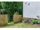 Back yard features a privacy fence, some mature trees, and level yard at 309 Cross Hill Ln, Holly Springs, NC 27540