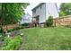 Spacious backyard featuring a well-maintained lawn, wooden fence, and a glimpse of surrounding greenery at 309 Cross Hill Ln, Holly Springs, NC 27540
