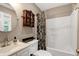 Bathroom with combination tub and shower and vanity with white countertop and sink at 309 Cross Hill Ln, Holly Springs, NC 27540