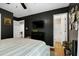 Bedroom with black walls, hardwood flooring, and a view of the bathroom at 309 Cross Hill Ln, Holly Springs, NC 27540