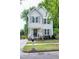 Charming two-story home with a well-maintained lawn, inviting curb appeal and decorative front door wreath at 309 Cross Hill Ln, Holly Springs, NC 27540