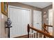 Second floor hallway features a neutral paint, white trim, and built-in closets at 309 Cross Hill Ln, Holly Springs, NC 27540