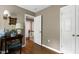 Hallway features a wood floor, neutral walls, and white doors at 309 Cross Hill Ln, Holly Springs, NC 27540