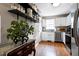 Bright kitchen with white cabinets, stainless steel appliances, and hardwood floors, offering lots of storage space at 309 Cross Hill Ln, Holly Springs, NC 27540