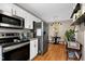 Well-equipped kitchen featuring stainless steel appliances, white cabinets, and a cozy dining nook at 309 Cross Hill Ln, Holly Springs, NC 27540