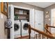 Second floor laundry room features a washer and dryer, shelving, and a neutral paint at 309 Cross Hill Ln, Holly Springs, NC 27540
