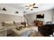 Comfortable living room featuring stylish furniture, patterned wallpaper accent and ceiling fan at 309 Cross Hill Ln, Holly Springs, NC 27540