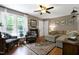 Inviting living room with a plush sofa, patterned accent chairs, and a large window for ample light at 309 Cross Hill Ln, Holly Springs, NC 27540