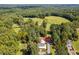Expansive estate aerial view with a pond, pasture and surrounded by lush forestry at 3123 Brassfield Rd, Creedmoor, NC 27522