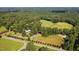 Aerial view of home featuring mature trees, surrounding acreage and a long driveway at 3123 Brassfield Rd, Creedmoor, NC 27522