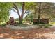 Secluded backyard featuring a brick fireplace, outdoor bar, and lush landscaping providing a tranquil retreat at 3123 Brassfield Rd, Creedmoor, NC 27522