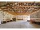 Spacious barn interior featuring exposed wooden beams, vintage furniture, and ample natural light at 3123 Brassfield Rd, Creedmoor, NC 27522
