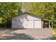 Large white barn featuring multiple doors and covered areas at 3123 Brassfield Rd, Creedmoor, NC 27522