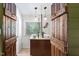 Bathroom featuring rustic barn door, dual vessel sinks, and modern lighting fixtures at 3123 Brassfield Rd, Creedmoor, NC 27522