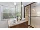 Bathroom featuring dual vessel sinks, granite countertops, and glass-enclosed shower at 3123 Brassfield Rd, Creedmoor, NC 27522