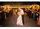 A couple kisses during an outdoor party with string lights and sparklers at 3123 Brassfield Rd, Creedmoor, NC 27522