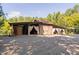 Rustic barn-style building with open-air spaces and draped fabric, offering versatile event possibilities at 3123 Brassfield Rd, Creedmoor, NC 27522