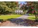 Charming two-story home with a front porch and mature trees at 3123 Brassfield Rd, Creedmoor, NC 27522