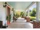 Spacious front porch with wood flooring, offering serene outdoor seating and views at 3123 Brassfield Rd, Creedmoor, NC 27522