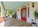 Charming front porch featuring ample seating and a classic red screen door at 3123 Brassfield Rd, Creedmoor, NC 27522