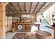 Rustic interior bar area with wood counter, patterned quilts, barrel, and vintage decor at 3123 Brassfield Rd, Creedmoor, NC 27522