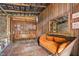 Rustic interior featuring a vintage couch, bench, and decorative elements, creating a cozy atmosphere at 3123 Brassfield Rd, Creedmoor, NC 27522