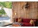 Cozy interior space featuring wooden walls, a red sofa, mounted turkey, and vintage accents at 3123 Brassfield Rd, Creedmoor, NC 27522