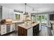Bright kitchen featuring white cabinets, a stainless steel island, and a charming breakfast nook at 3123 Brassfield Rd, Creedmoor, NC 27522
